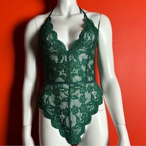 Green lace bodysuit with floral pattern and adjustable straps